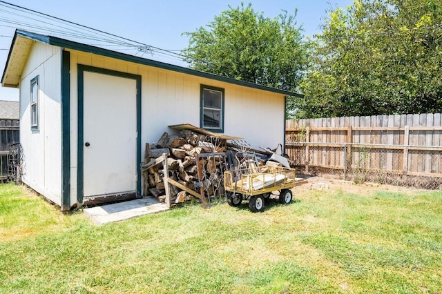 view of outdoor structure with an outbuilding and fence