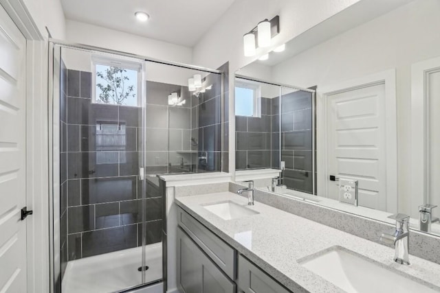 bathroom featuring a stall shower, a sink, and plenty of natural light