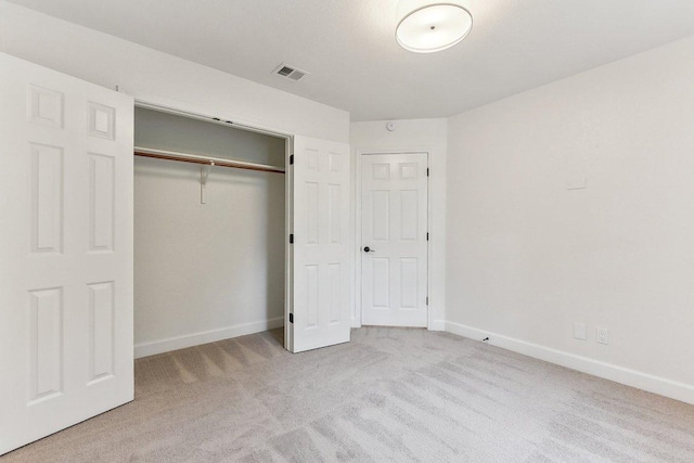 unfurnished bedroom featuring visible vents, a closet, carpet flooring, and baseboards