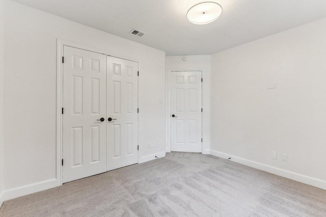 unfurnished bedroom with visible vents, baseboards, carpet flooring, and a closet