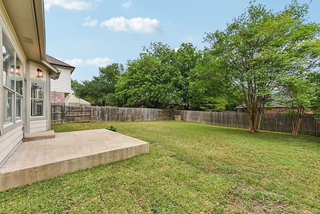 view of yard featuring a patio and a fenced backyard