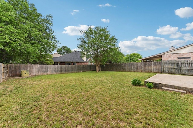 view of yard with a patio and a fenced backyard