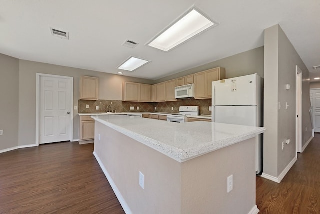 kitchen featuring light brown cabinetry, dark wood finished floors, visible vents, and white appliances