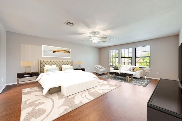 bedroom featuring visible vents, ceiling fan, wood finished floors, and baseboards