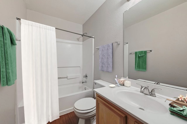 full bath with toilet, wood finished floors, bathing tub / shower combination, and vanity
