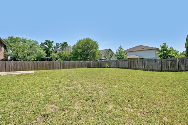 view of yard with a fenced backyard