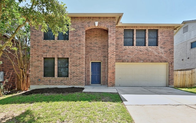 view of front of house featuring brick siding, fence, a garage, driveway, and a front yard