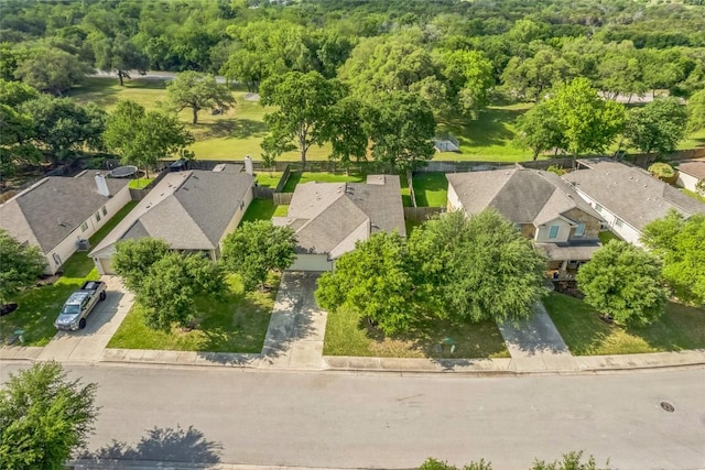 birds eye view of property with a residential view and a view of trees