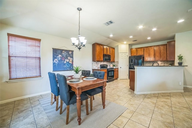 dining area featuring an inviting chandelier, light tile patterned floors, visible vents, and baseboards
