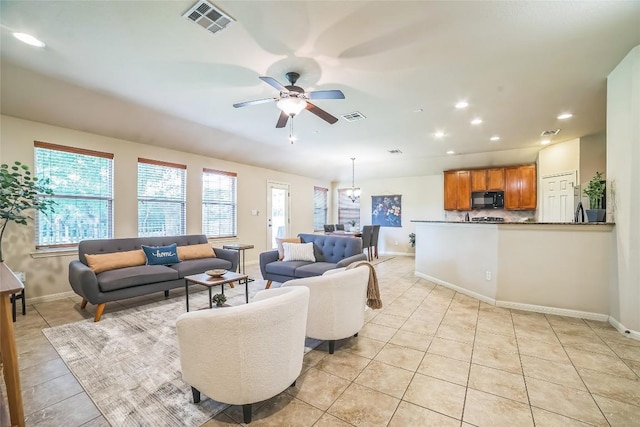 living room featuring recessed lighting, light tile patterned floors, ceiling fan, baseboards, and visible vents