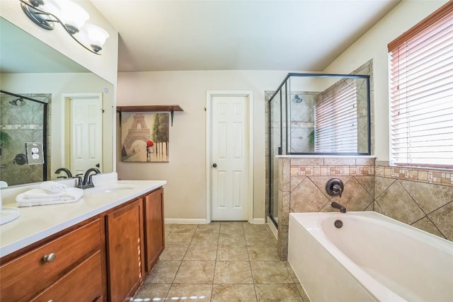 bathroom with vanity, tile patterned floors, a stall shower, baseboards, and a garden tub