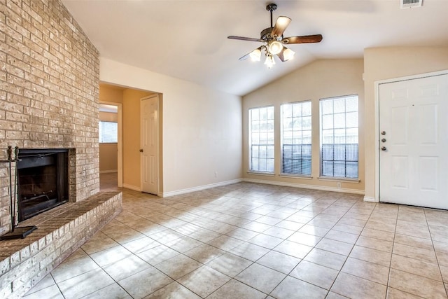 unfurnished living room featuring lofted ceiling, light tile patterned floors, ceiling fan, visible vents, and a brick fireplace