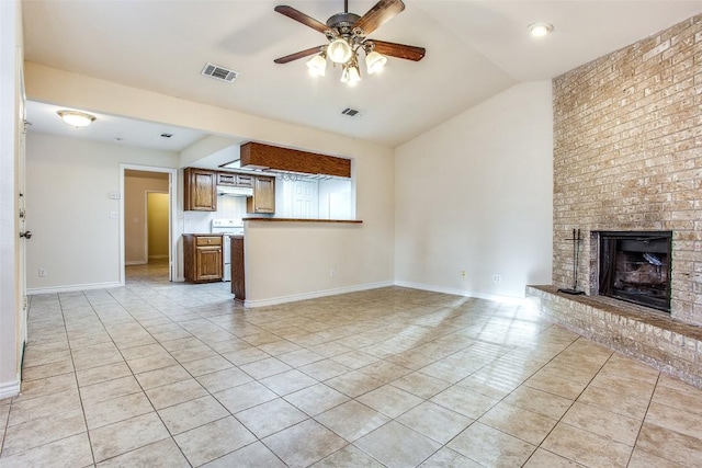 unfurnished living room with a fireplace, light tile patterned floors, ceiling fan, visible vents, and lofted ceiling