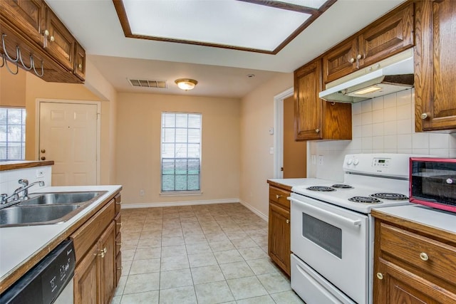 kitchen with a sink, white range with electric stovetop, visible vents, under cabinet range hood, and dishwashing machine