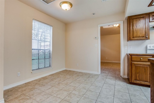 interior space featuring baseboards and light tile patterned floors