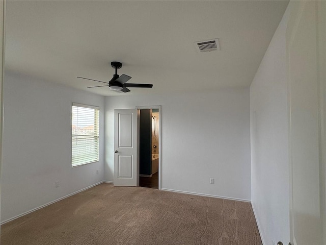unfurnished bedroom with connected bathroom, visible vents, ceiling fan, baseboards, and carpet