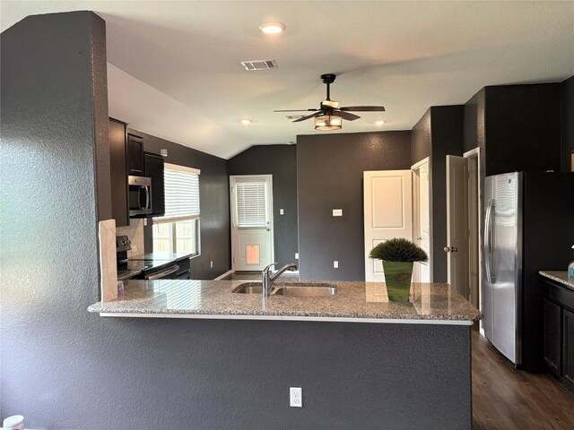 kitchen with appliances with stainless steel finishes, a sink, visible vents, a ceiling fan, and lofted ceiling