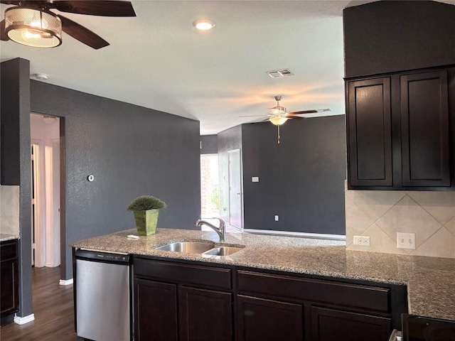 kitchen featuring a sink, a ceiling fan, visible vents, light stone counters, and dishwasher