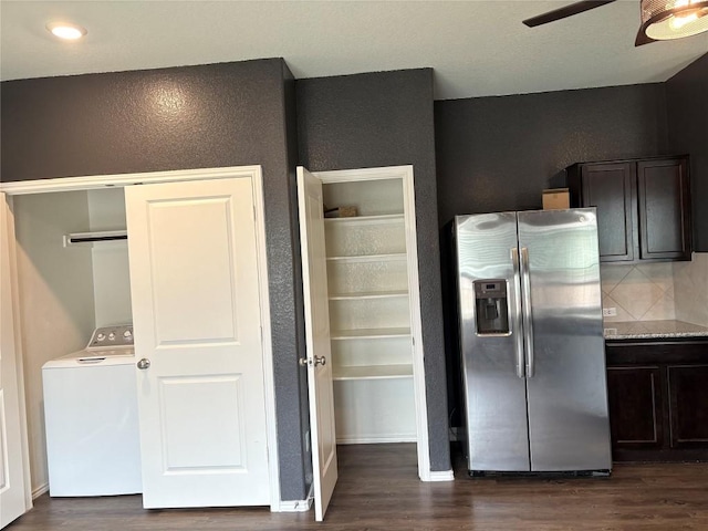 kitchen with dark wood-style floors, a ceiling fan, washer / dryer, and stainless steel fridge