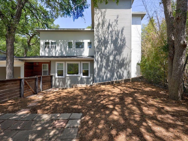 back of property with fence