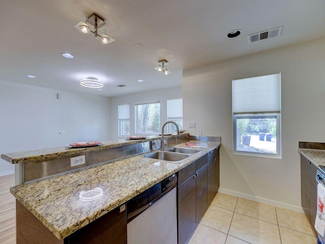 kitchen with a sink, visible vents, a peninsula, baseboards, and dishwasher