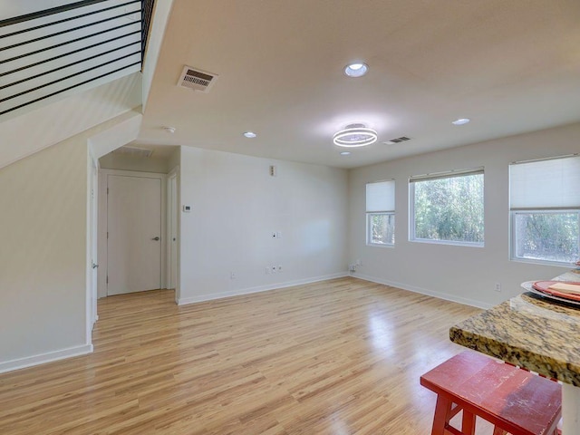 unfurnished living room with visible vents, light wood-type flooring, recessed lighting, and baseboards