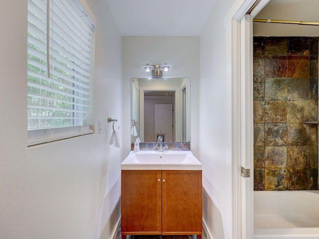bathroom with bathing tub / shower combination and vanity