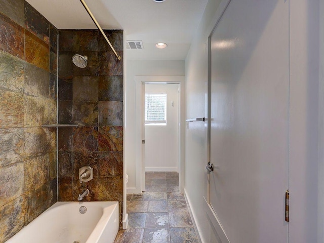 bathroom with baseboards, recessed lighting, shower / bathing tub combination, stone tile floors, and visible vents
