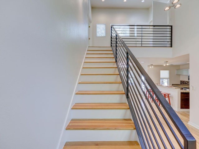 stairway featuring recessed lighting and wood finished floors