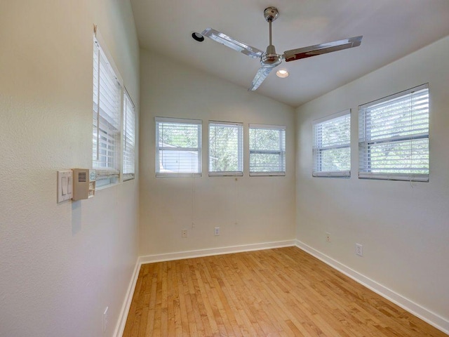 unfurnished room with ceiling fan, baseboards, lofted ceiling, and light wood-type flooring
