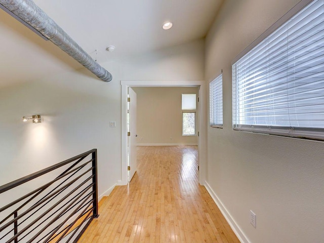 hallway with recessed lighting, baseboards, and light wood-style floors