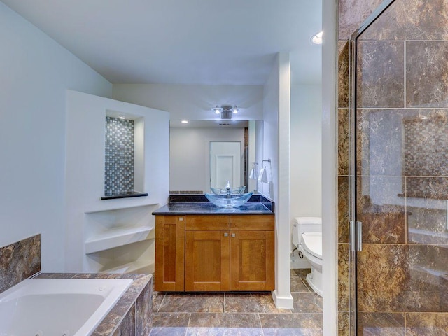 bathroom with a shower stall, toilet, a whirlpool tub, and vanity