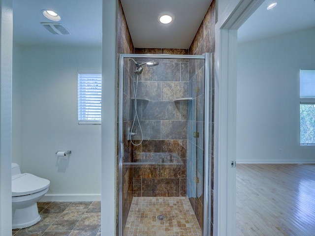 bathroom featuring visible vents, a stall shower, baseboards, toilet, and recessed lighting
