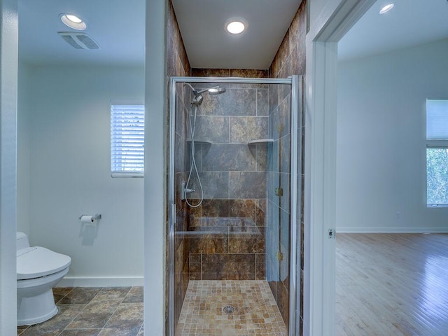 400 E 33rd St Unit 2, Austin, TX 78705 - bathroom featuring baseboards, toilet, a shower stall, and recessed lighting