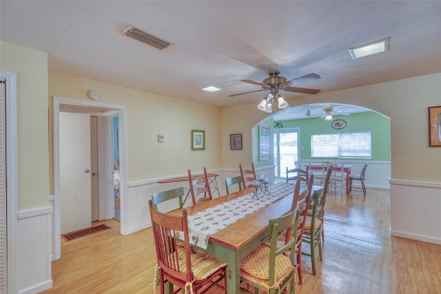 1833 Highland Dr, Marble Falls, TX 78654 - dining area with visible vents, light wood-type flooring, a ceiling fan, and arched walkways