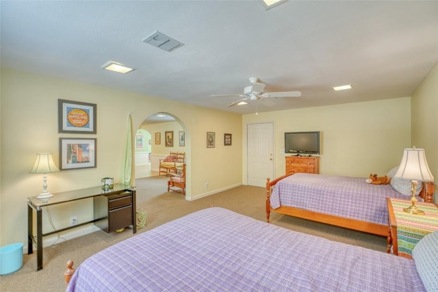 1833 Highland Dr, Marble Falls, TX 78654 - carpeted bedroom featuring visible vents, ceiling fan, baseboards, and arched walkways
