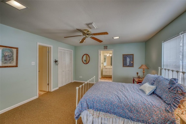 1833 Highland Dr, Marble Falls, TX 78654 - carpeted bedroom featuring connected bathroom, a closet, a ceiling fan, visible vents, and baseboards