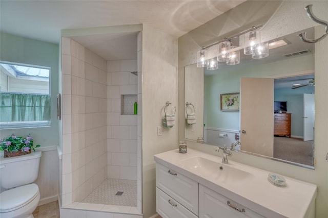 1833 Highland Dr, Marble Falls, TX 78654 - bathroom with a skylight, a tile shower, toilet, vanity, and visible vents