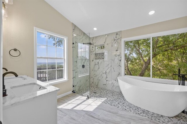 510 Circle Rd, Horseshoe Bay, TX 78657 - bathroom featuring marble look tile flooring, a freestanding tub, a marble finish shower, recessed lighting, and double vanity
