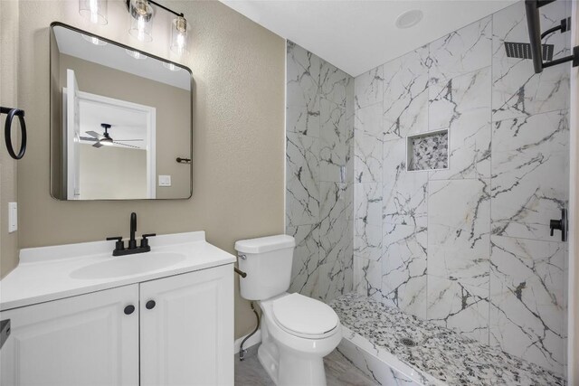 510 Circle Rd, Horseshoe Bay, TX 78657 - full bathroom featuring vanity, ceiling fan, a marble finish shower, and a textured wall