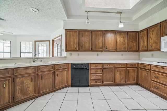kitchen with white appliances, a textured ceiling, light countertops, and a sink