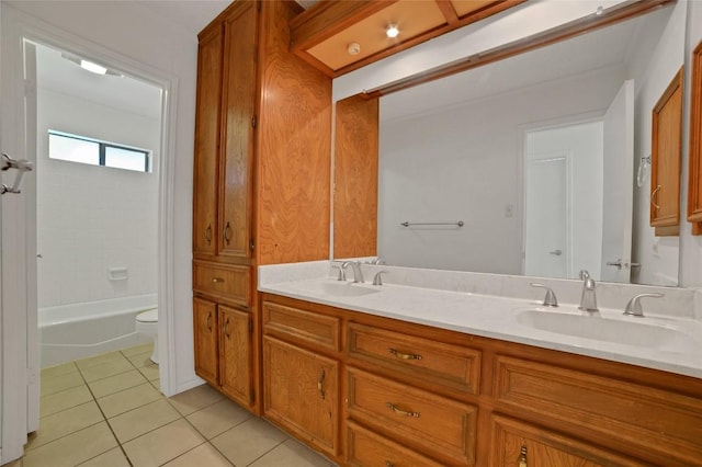 bathroom featuring toilet, tile patterned flooring, a sink, and double vanity