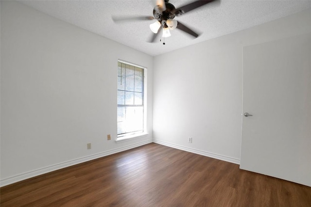 unfurnished room with dark wood finished floors, baseboards, a ceiling fan, and a textured ceiling