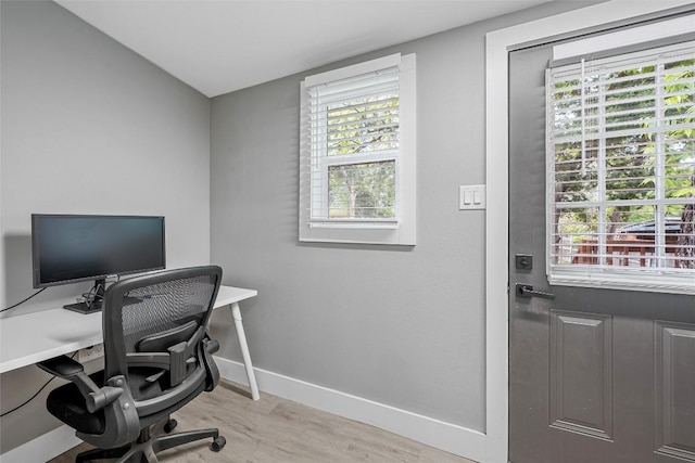 home office featuring plenty of natural light, light wood-style flooring, and baseboards