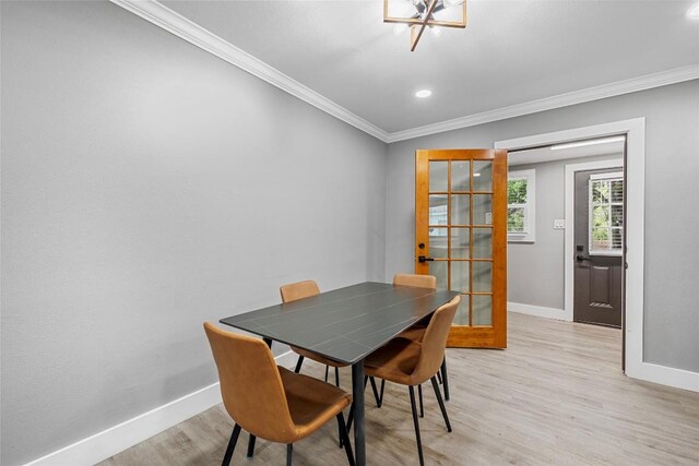 dining space featuring crown molding, light wood-style floors, baseboards, recessed lighting, and french doors