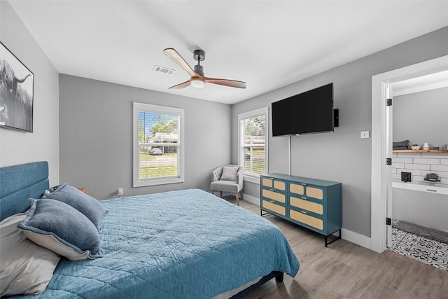 bedroom with visible vents, ceiling fan, wood finished floors, and baseboards