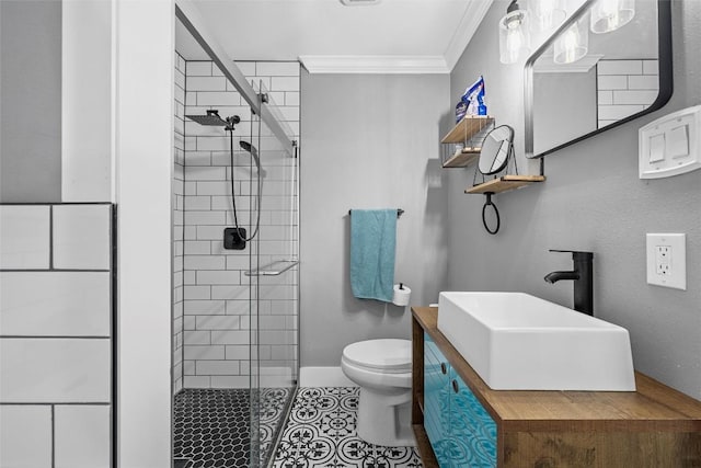 bathroom with tile patterned floors, toilet, a stall shower, baseboards, and ornamental molding