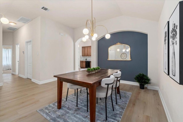 231 Skinner, Kyle, TX 78640 - dining area with light wood finished floors, arched walkways, baseboards, and lofted ceiling