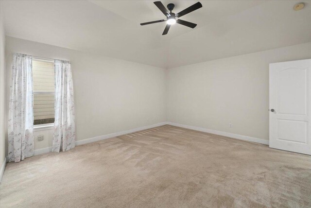 231 Skinner, Kyle, TX 78640 - empty room featuring carpet floors, baseboards, ceiling fan, a smoke detector, and vaulted ceiling
