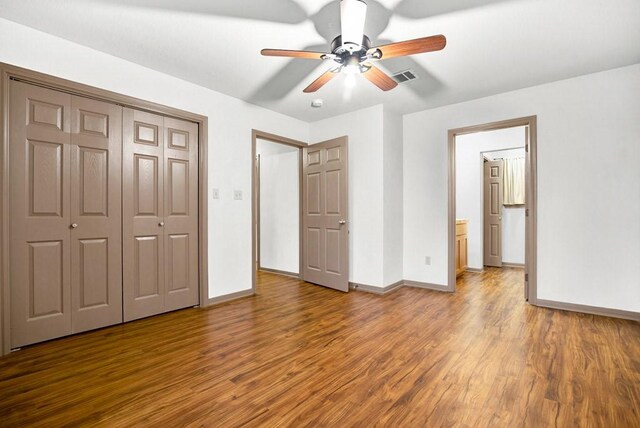 121 Hudson Rd, Smithville, TX 78957 - unfurnished bedroom with wood finished floors, a closet, and a ceiling fan